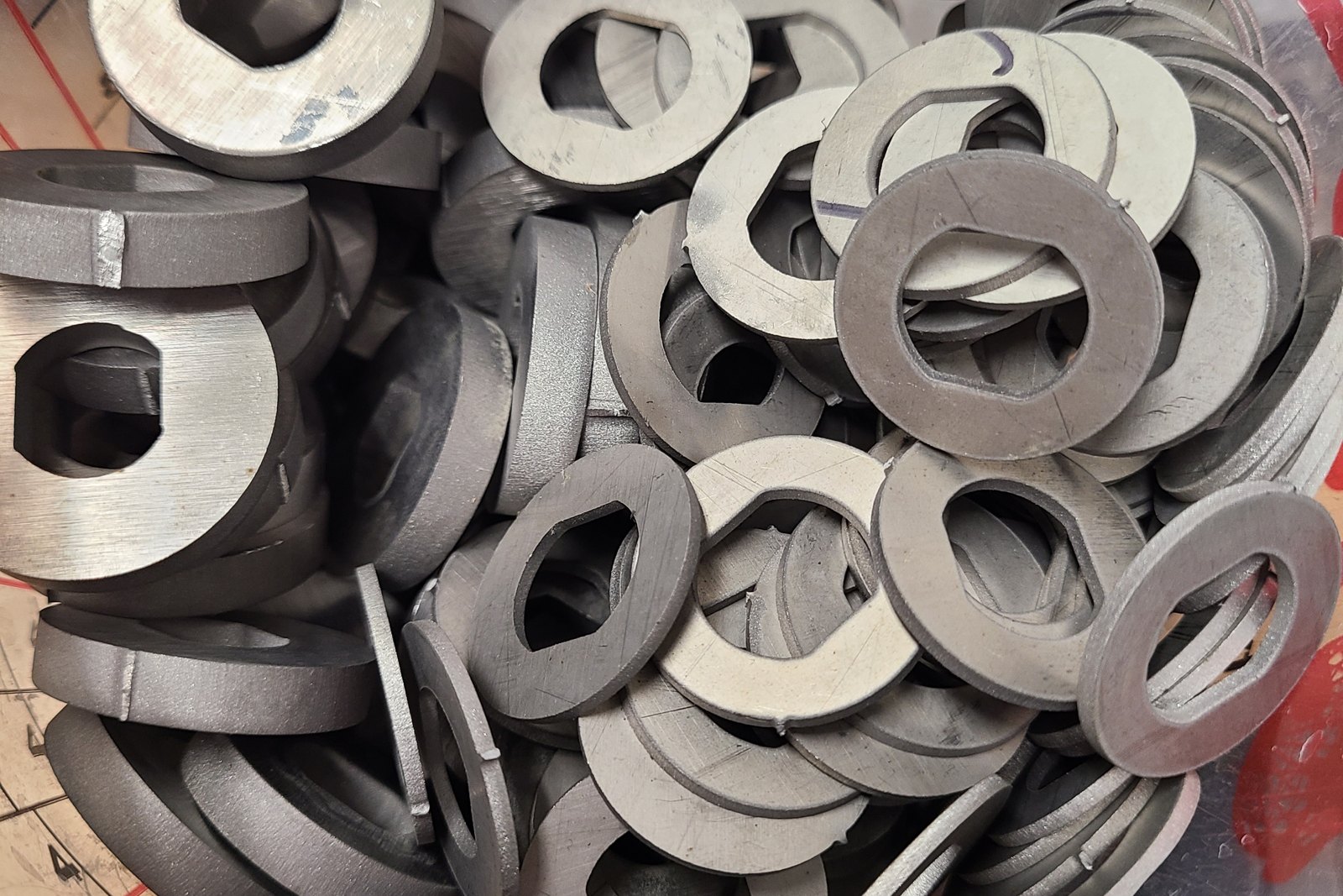 Bin of machined washers with double-D bores
