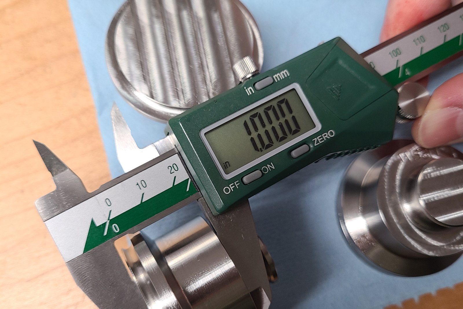 Digital caliper reading 1.000 inch on a machined part