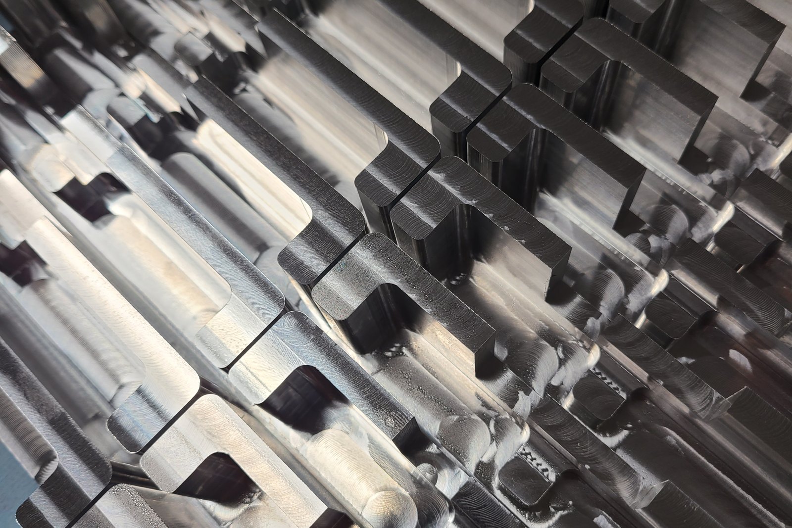 Close-up of rows of machined pockets and walls in a metal part