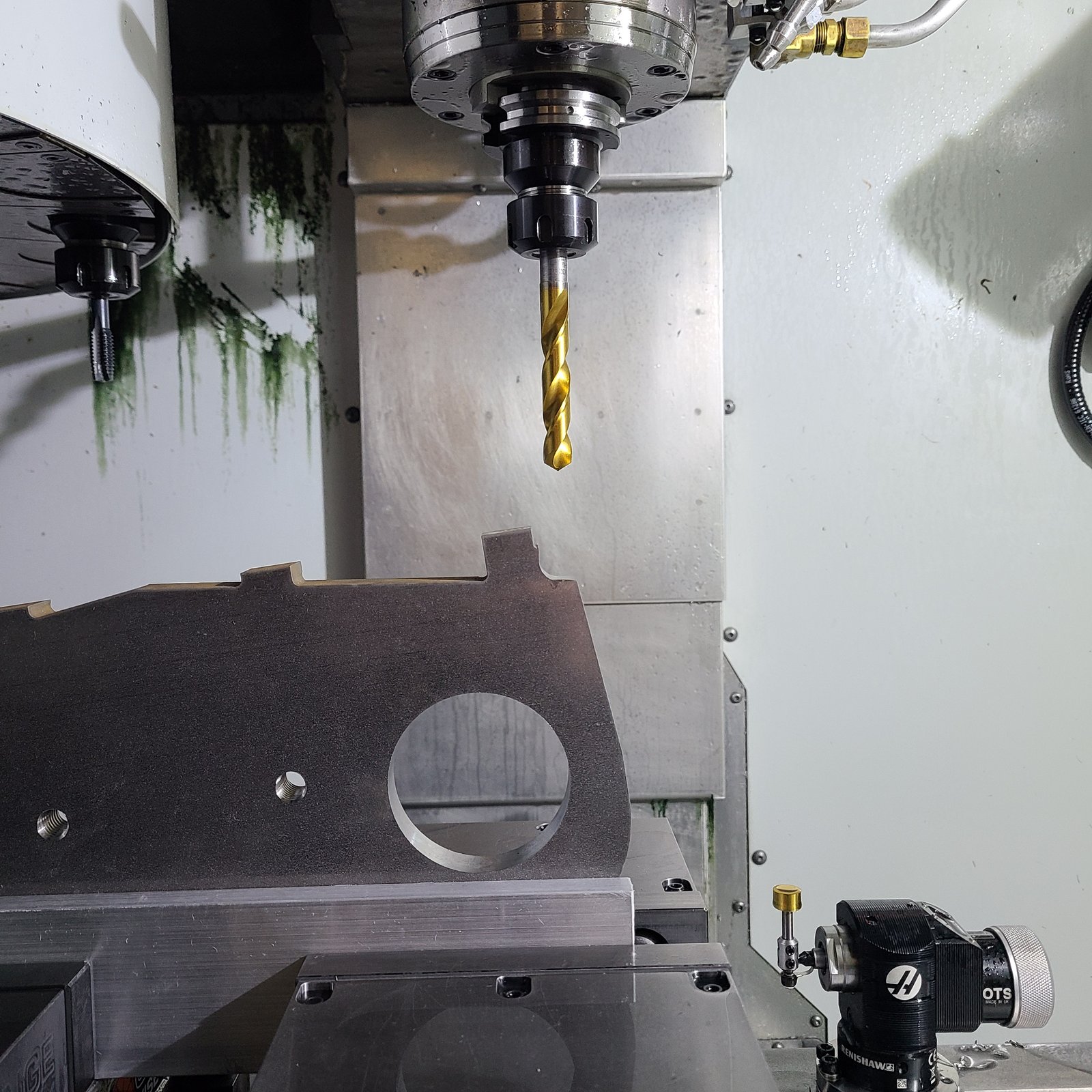 Inside the mill enclosure: drill in the spindle over a fixtured part